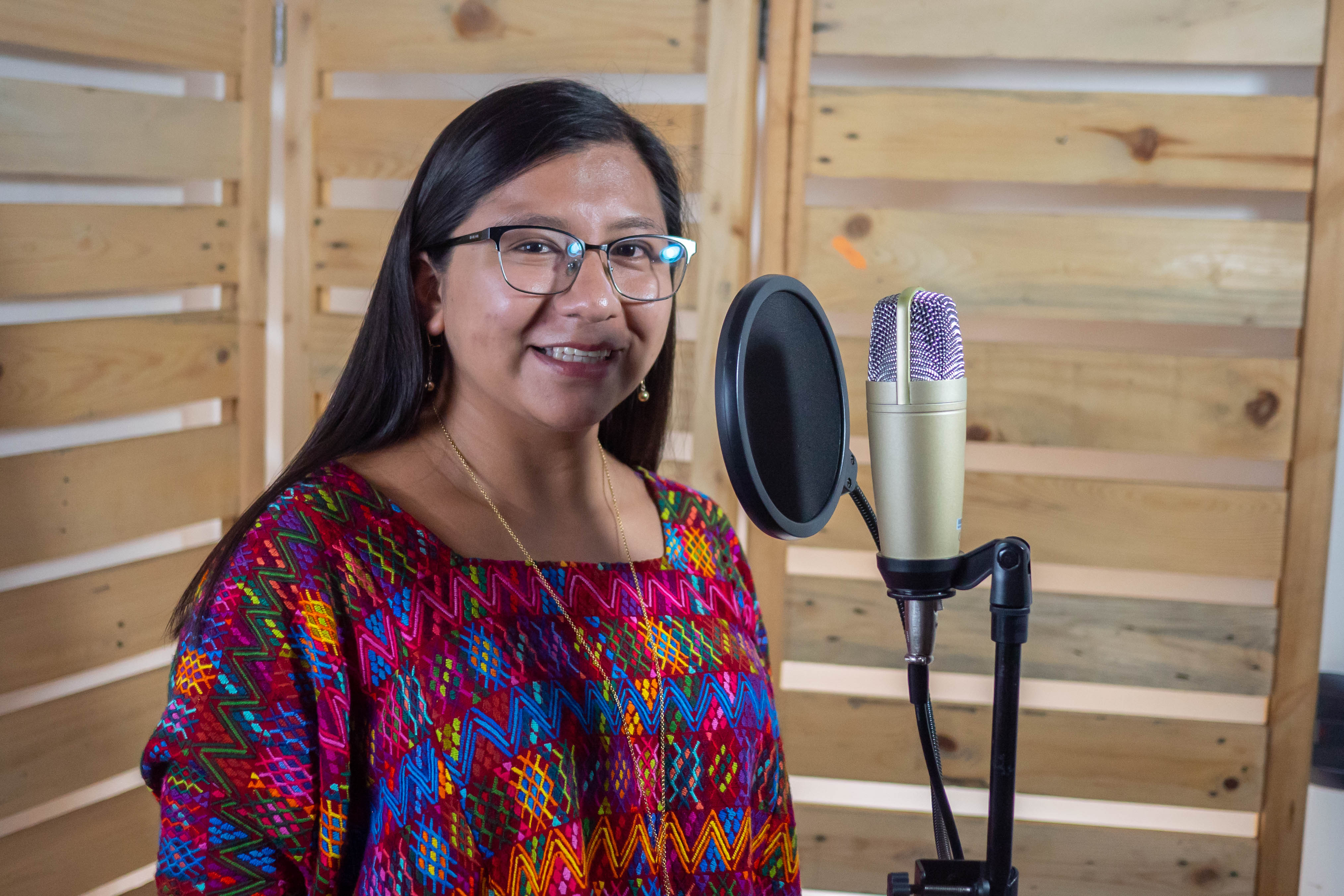 Mujer maya sonriendo frente a microfono